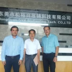 SYX Group leadership and client representatives in front of factory showroom