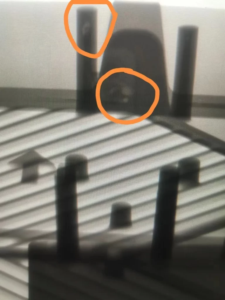X-ray of die-cast component showing porosity defects marked in orange circles
